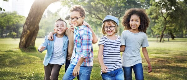 A group of kids standing in the grass.